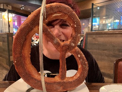 woman behind large pretzel