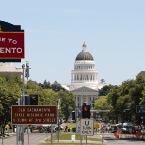 downtown sacramento, california with welcome to sacrament sign in the foreground