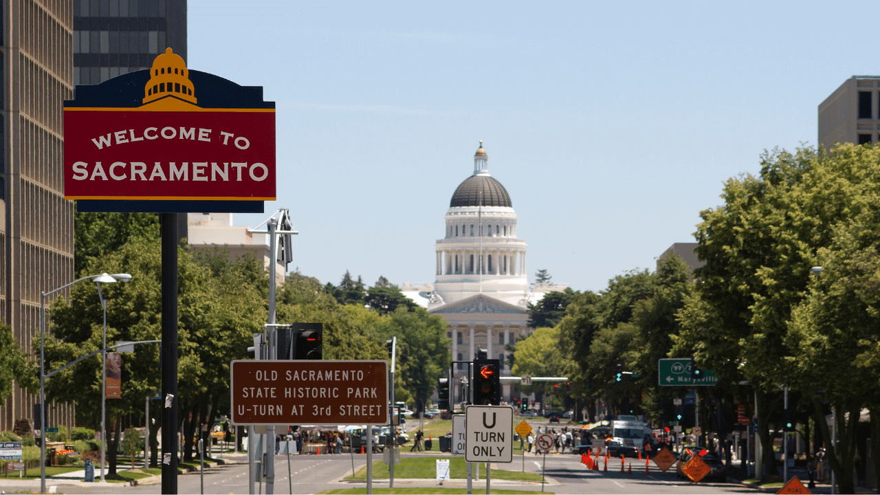 downtown sacramento, california with welcome to sacrament sign in the foreground