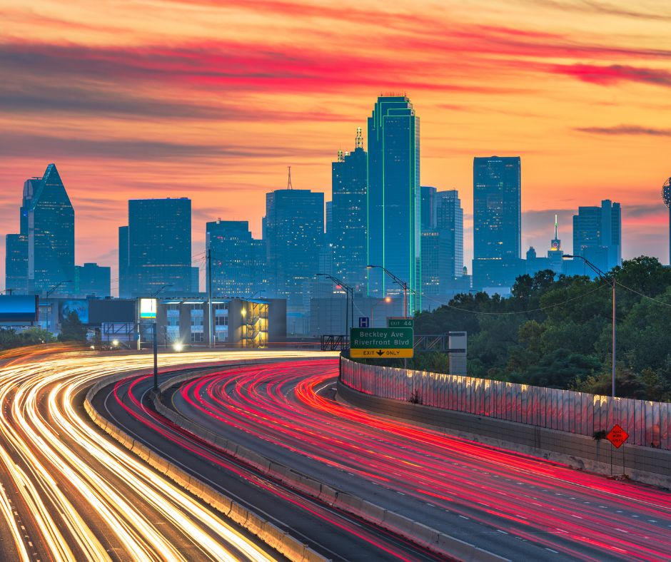 downtown Dallas Texas skyline with traffic at dusk