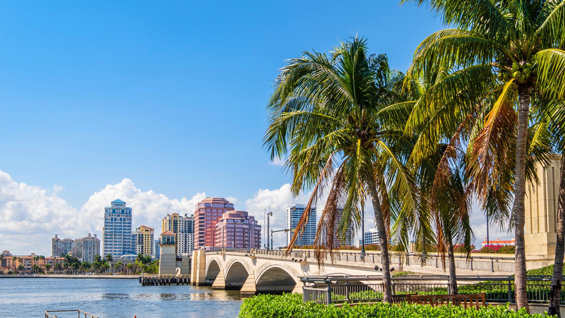 Bridge in West Palm Beach connecting palm trees to downtown